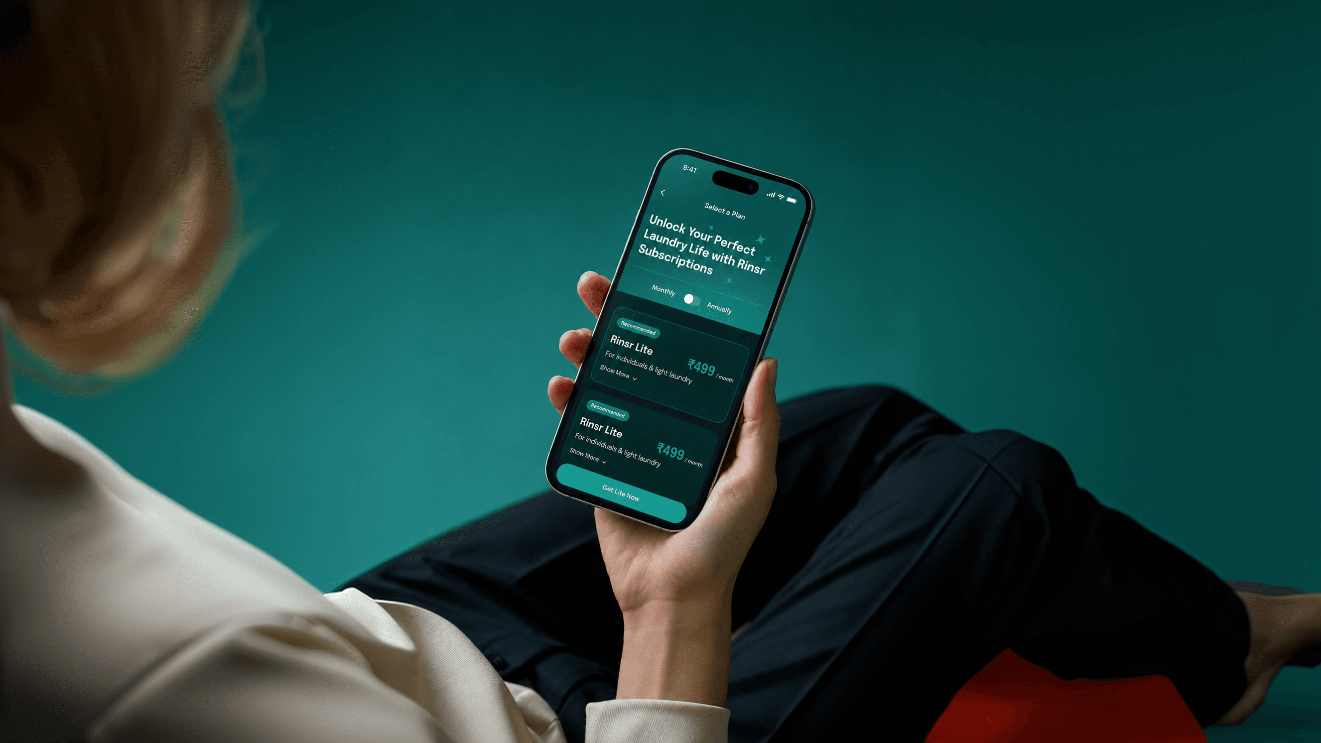 A person relaxing with a phone open on RINSR's flat-rate subscription plans